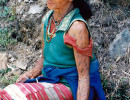 10 tattooed woman sitting on the side of the road 800